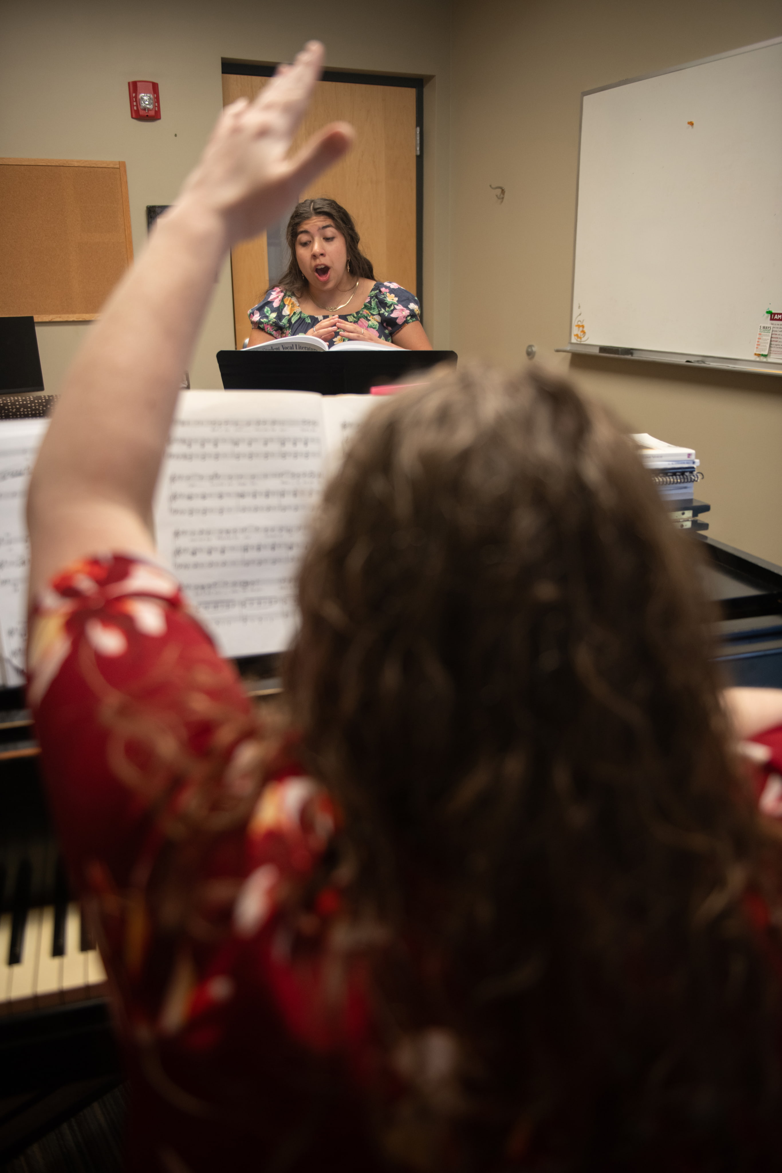 Student singing for professor.