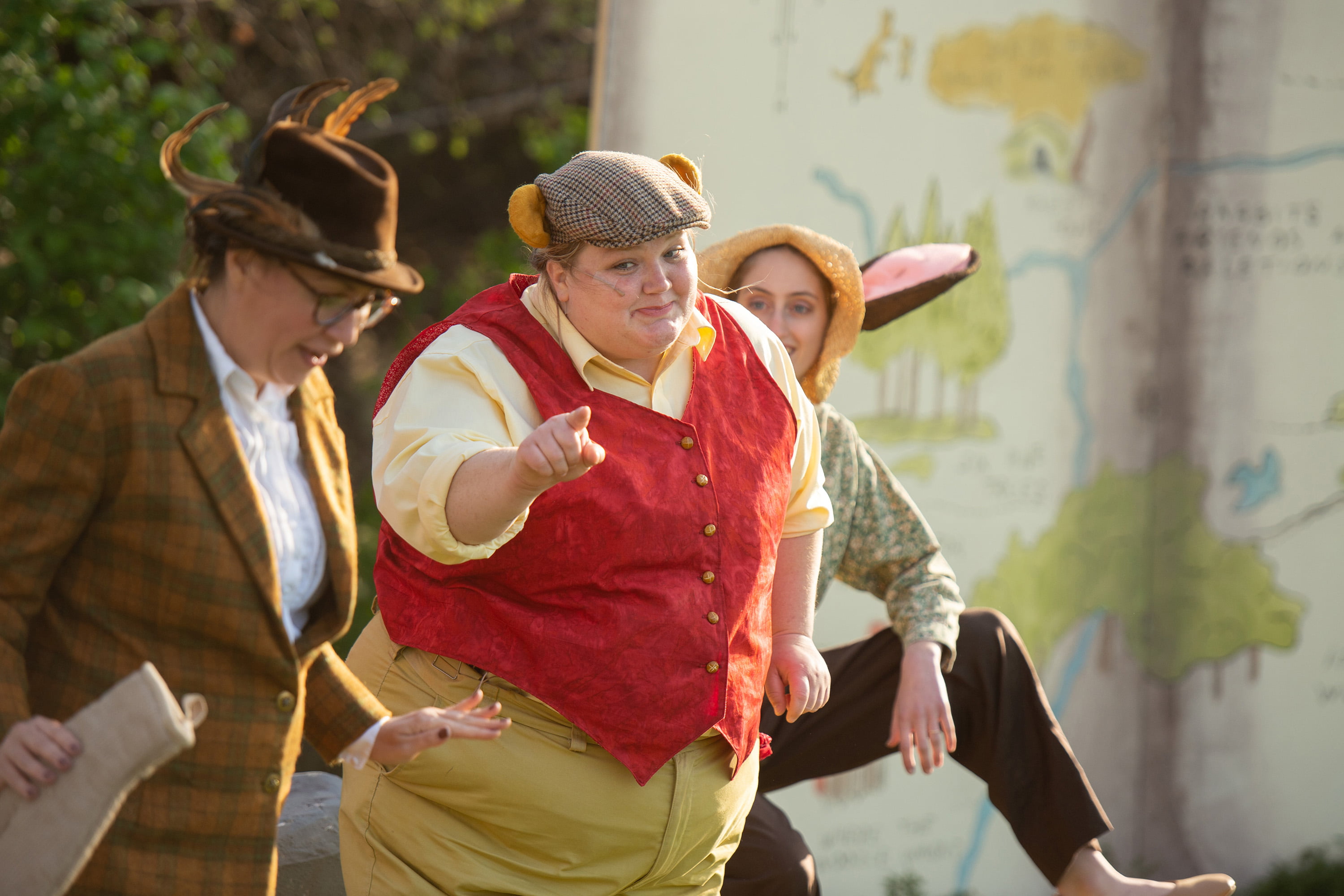 Three student performers wearing costumes.