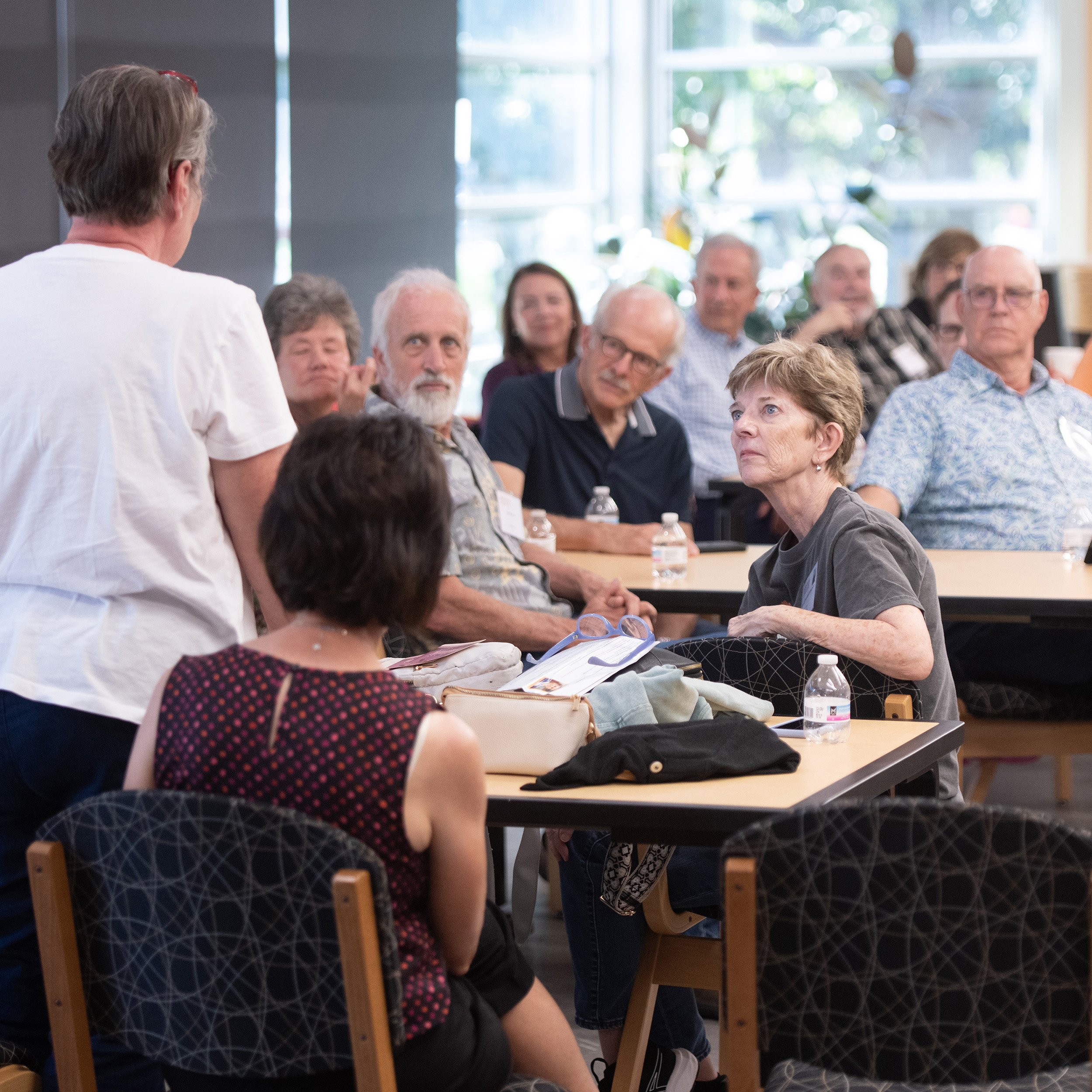 Hesston College Homecoming 2025 - Members of the Hesston College class of 1975 listen intently as a classmate shares an update on her life.