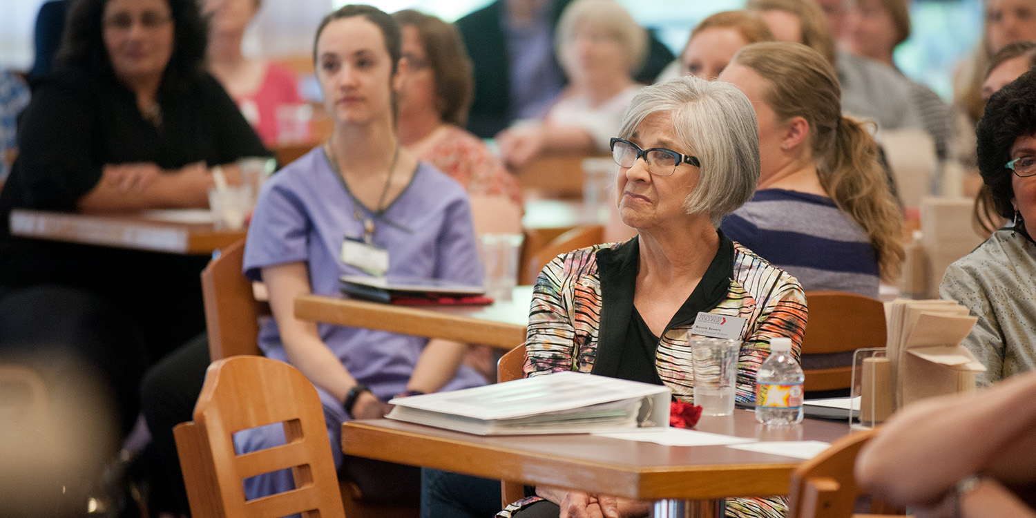 photo - Bonnie Sowers listens to tributes at a reception in her honor.