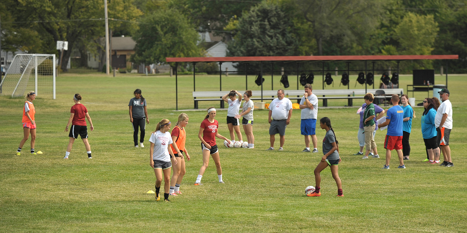 photo - Hesston College women's soccer players demonstrate drills at a clinic for prospective Special Olympics coaches.