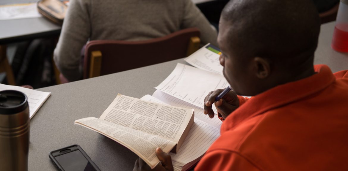 Photo: a student reading the Bible in Biblical Literature class at Hesston College