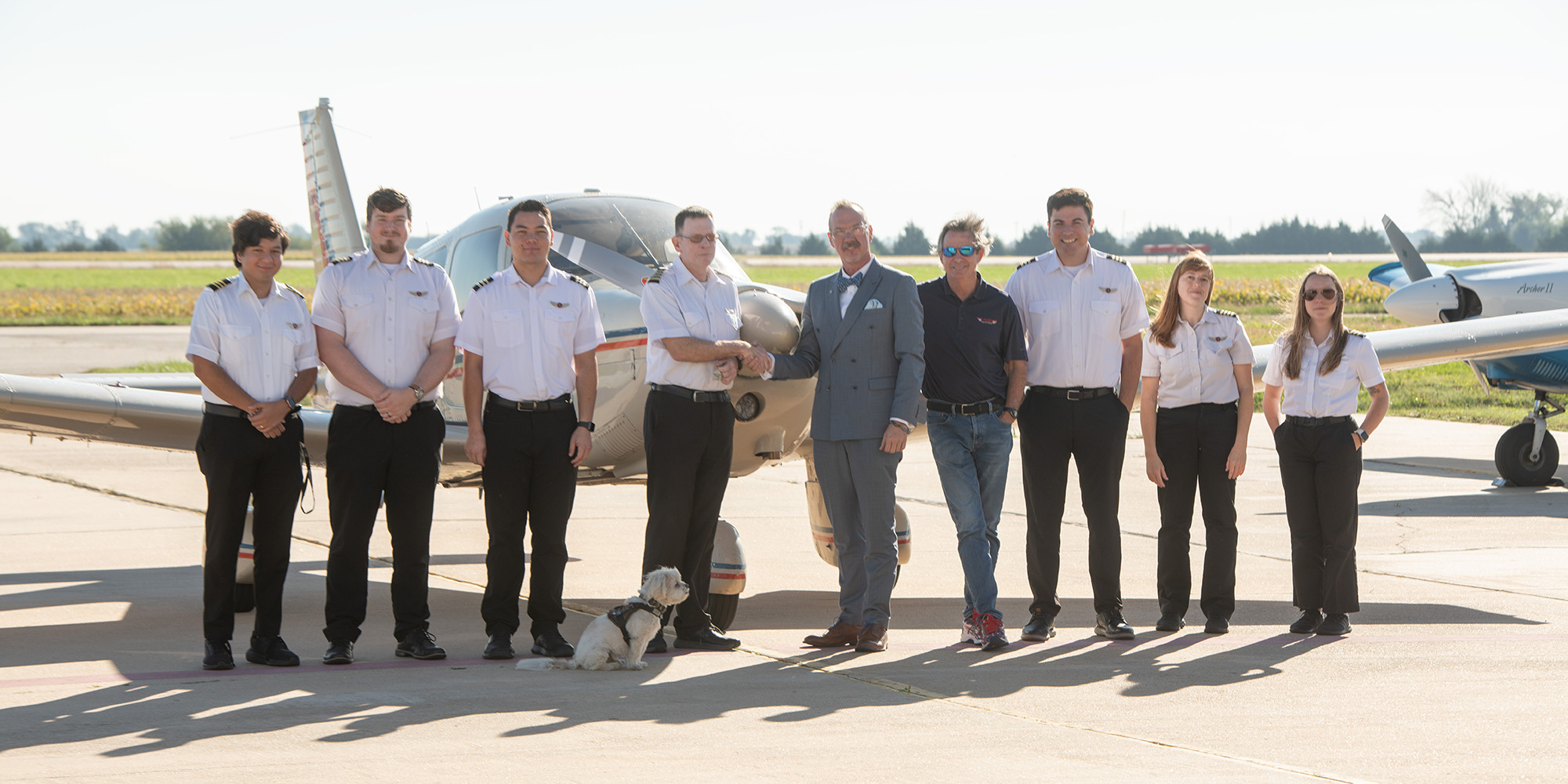 Hesston College Aviaton flight instructors and program director Mike Baker take delivery of a 1983 Piper Archer II, the latest addition to the department's fleet of training aircraft.