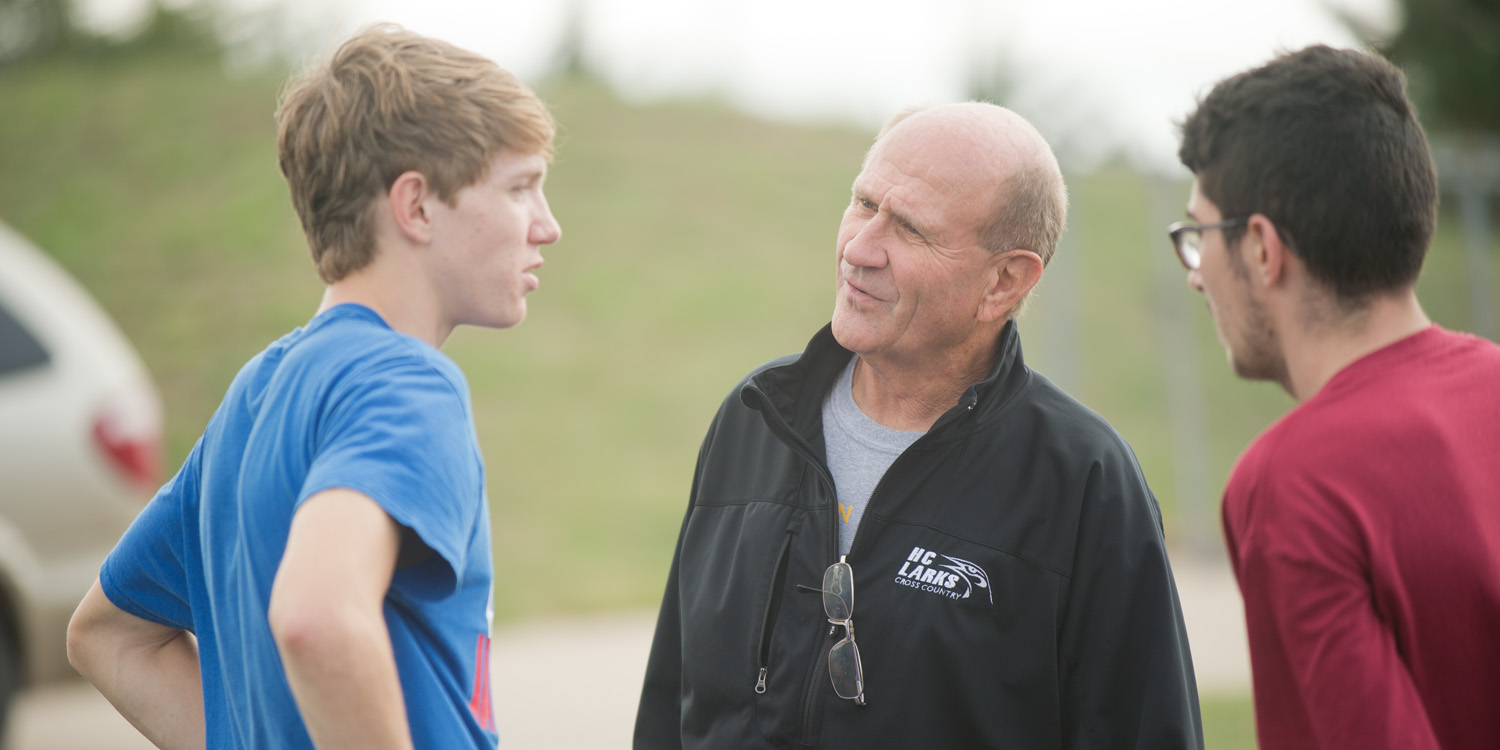 photo - Coach Gerry Sieber talks with his runners at practice.