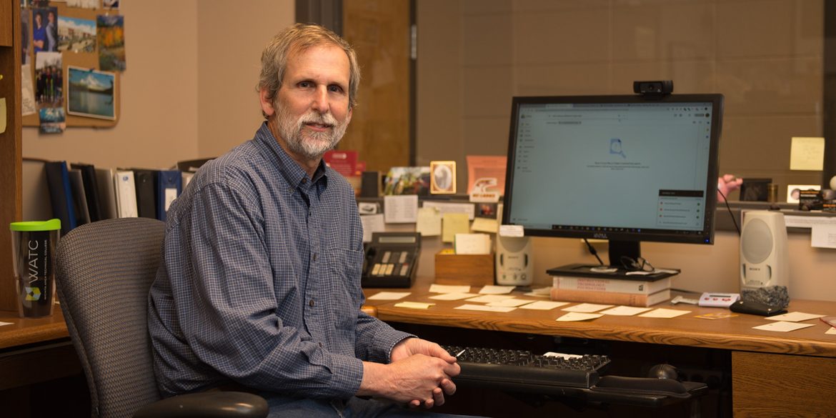 Photo: Gary Oyer at his desk in the Media and Instructional Technology Services office in Smith Center