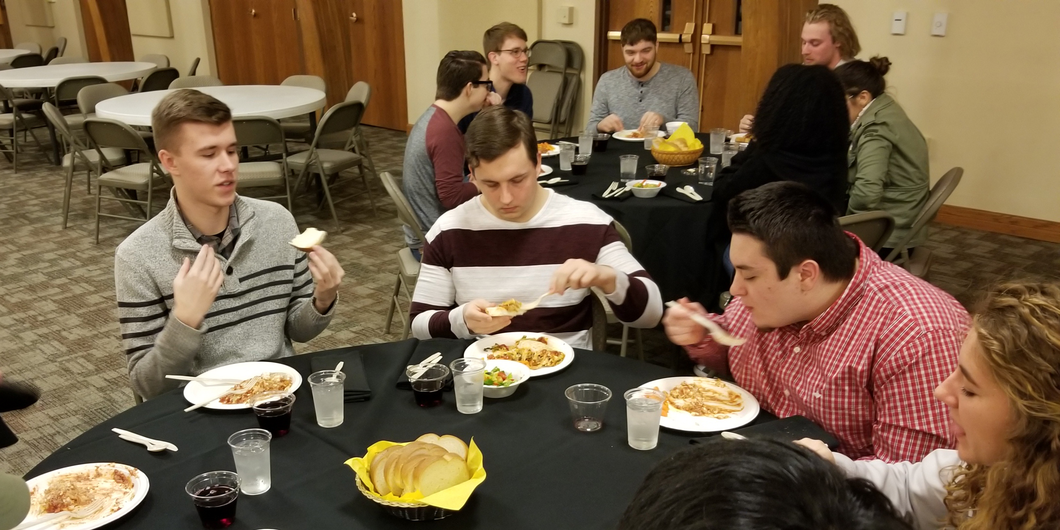 photo - Students at a Jefferson Dinner discuss the value of college and education.