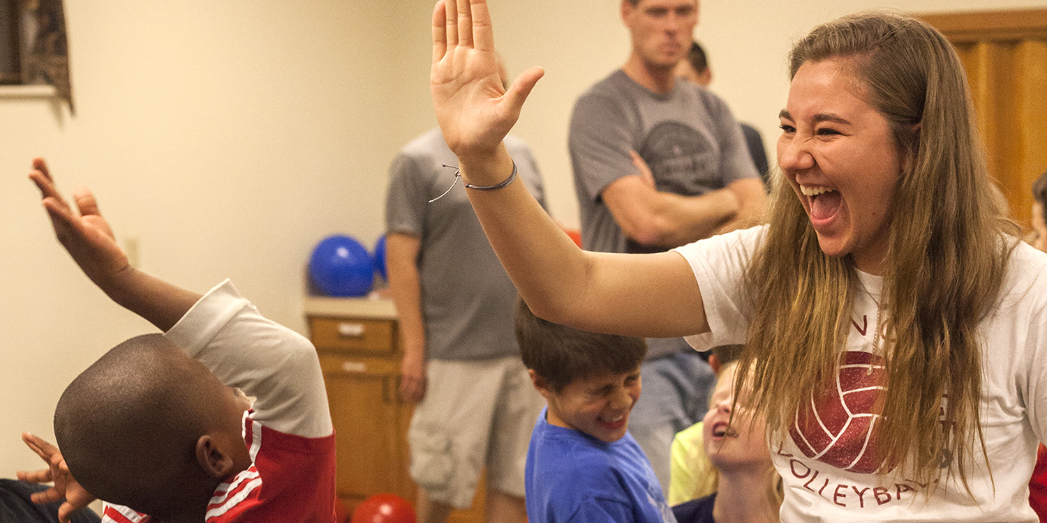 photo - Freshman Cassidy King high fives a WOW participant during a game