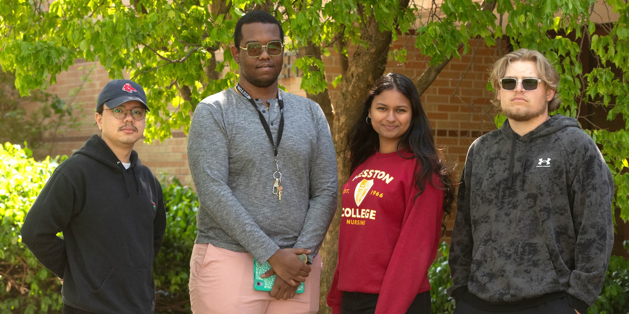 Four students pose for photo after winning.